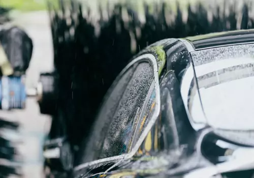 A vehicle being directed through a car wash that is using a water reclaim & recycling system installed by SoBrite Technologies